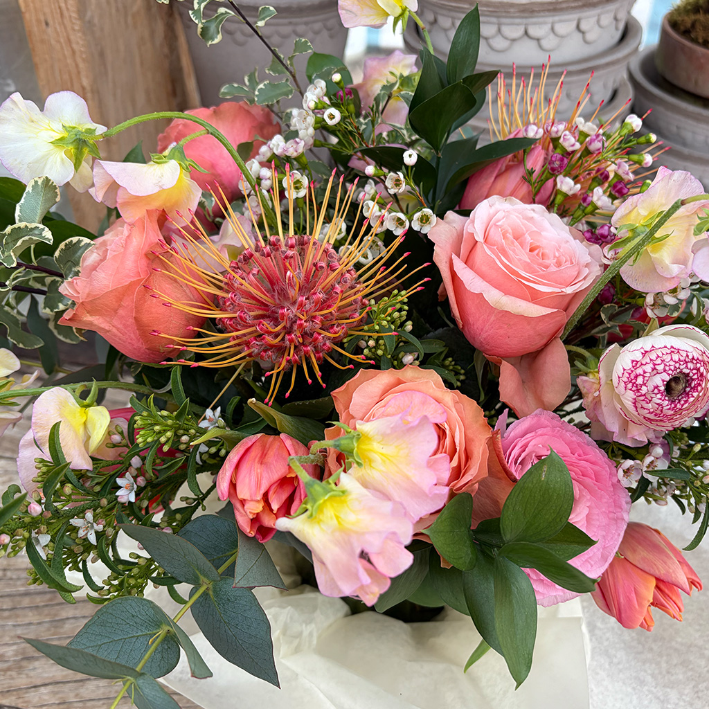 Floral centerpiece with vibrant seasonal blooms by Wild Beauty Floral Design