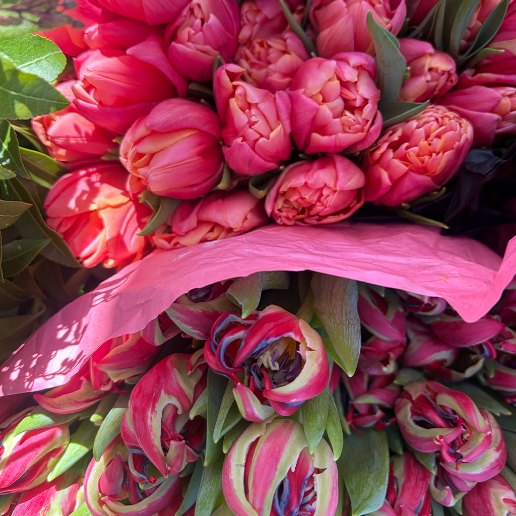 Floral centerpiece with vibrant seasonal blooms by Wild Beauty Floral Design