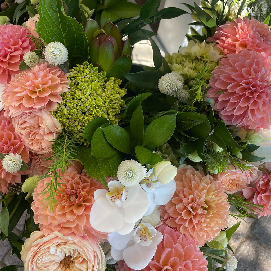 Floral centerpiece with vibrant seasonal blooms by Wild Beauty Floral Design